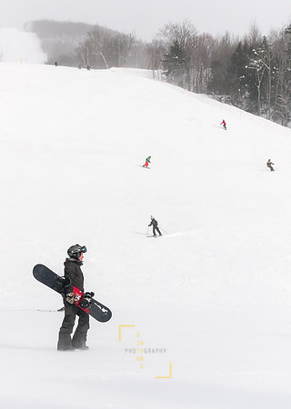 Snowboarder and Skiers